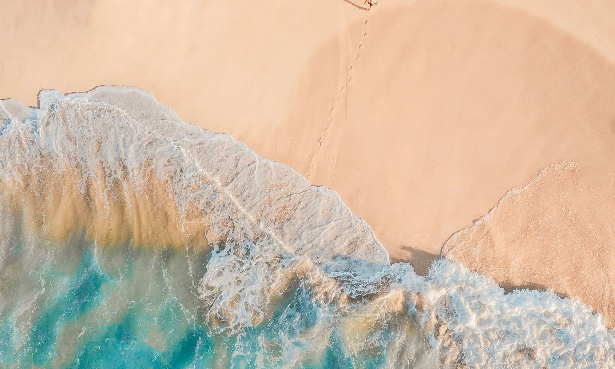 Calm, clear water over pale sand