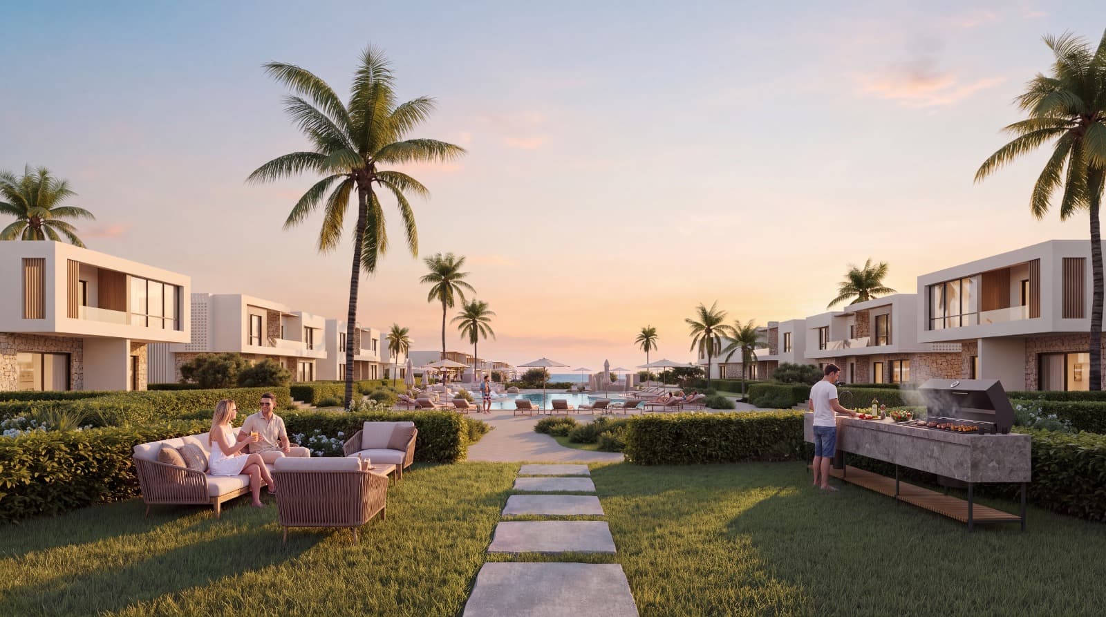 A garden path between NAVAIA residences leading to the pool and the sea at sunset